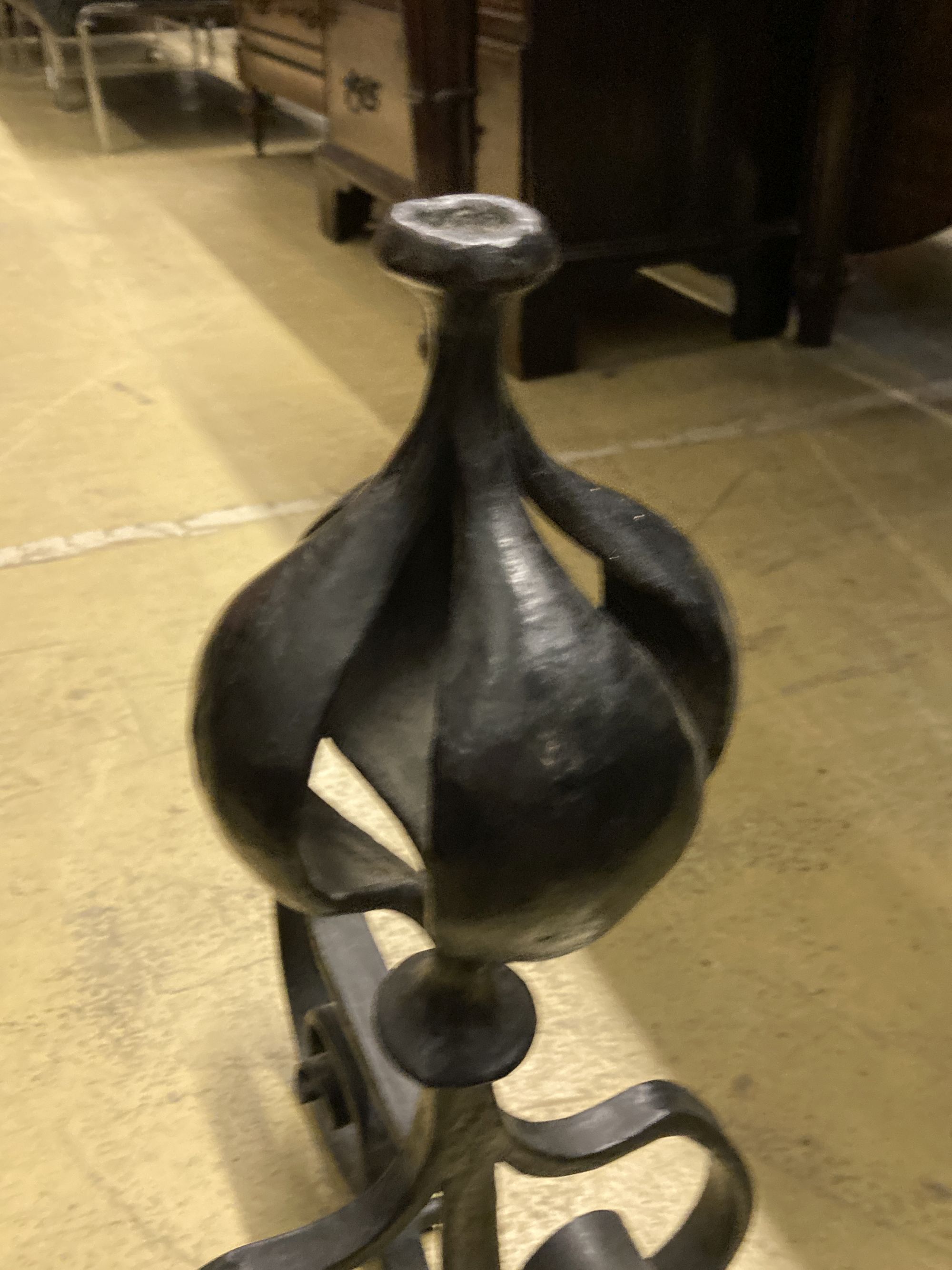 A George III pierced steel serpentine fender, length 130cm, together with a pair of wrought iron firedogs